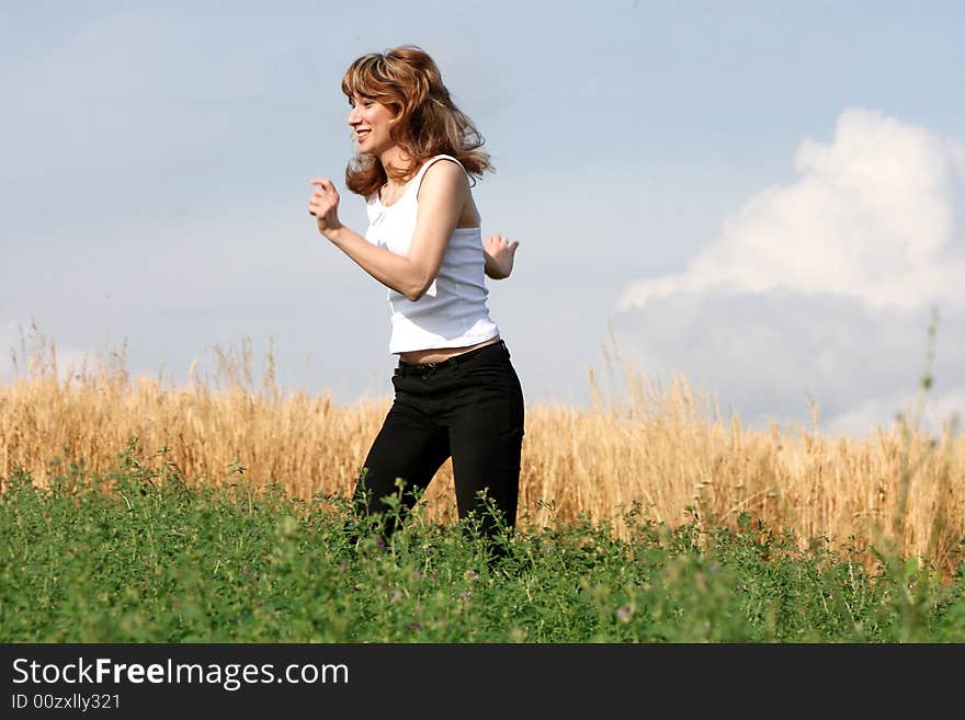 A beautiful girl running on the field