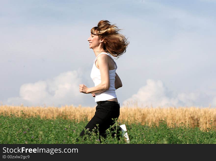 A beautiful girl running on the field