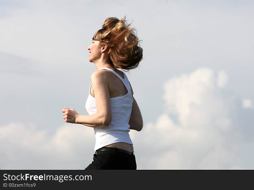 A beautiful girl running on the field