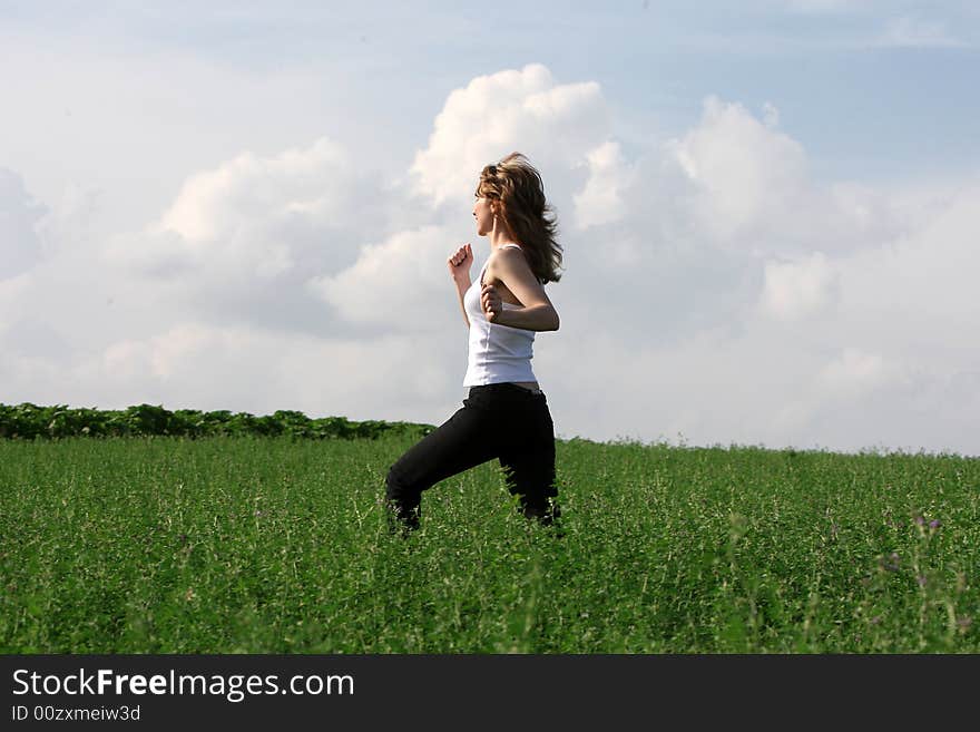 A beautiful girl running on the field