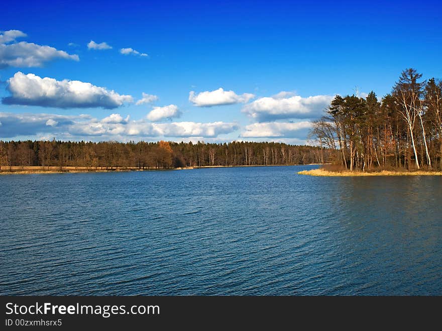 A blue lake and blue skies