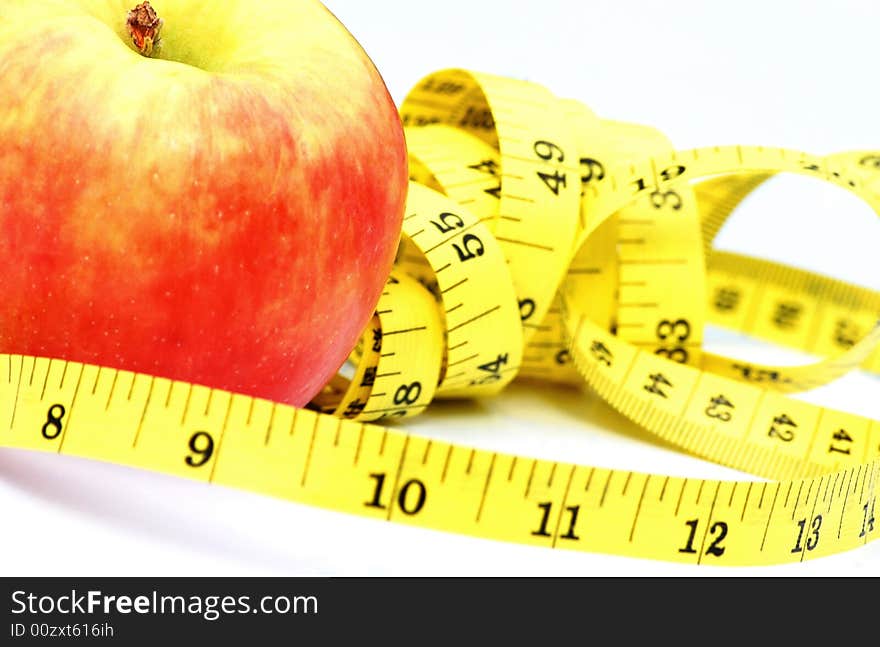 A shot of an apple with tape measure. A shot of an apple with tape measure