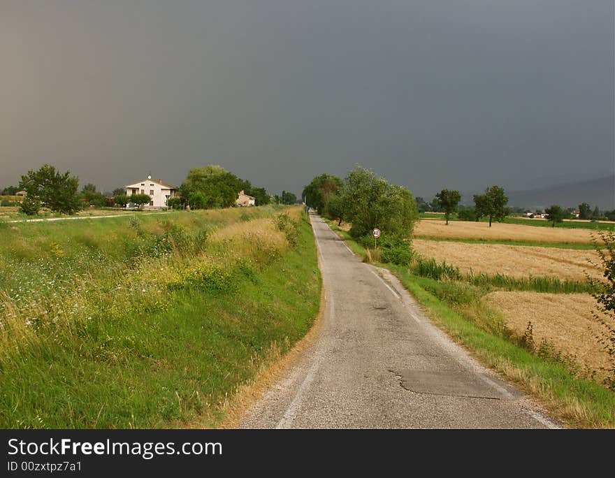 Umbria landscape with road and storm clouds. Umbria landscape with road and storm clouds