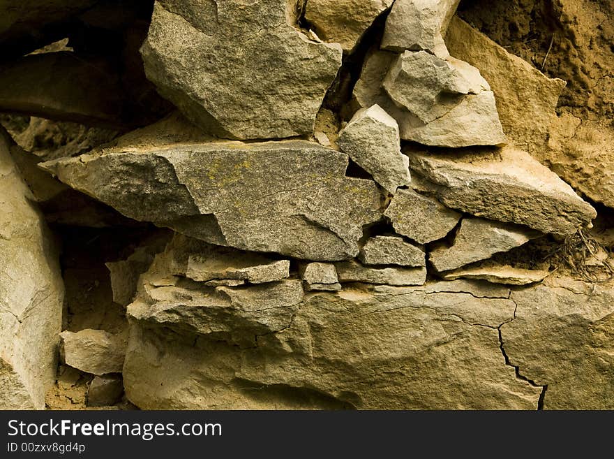 Old stone wall with the blasted laying