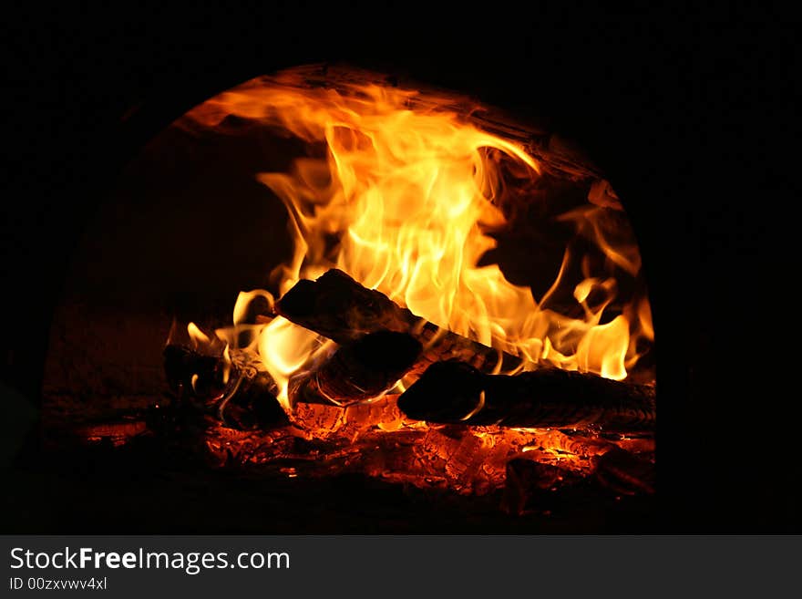 Big flames from a fire burning inside an oven. Big flames from a fire burning inside an oven