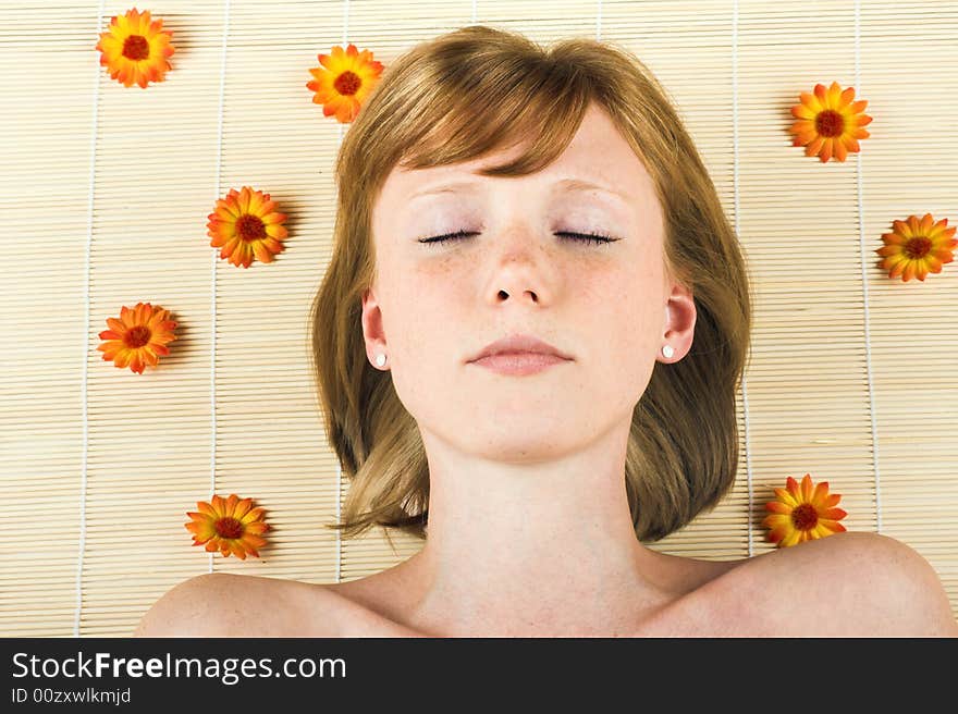 Young beautiful woman in a spa with flowers. Young beautiful woman in a spa with flowers