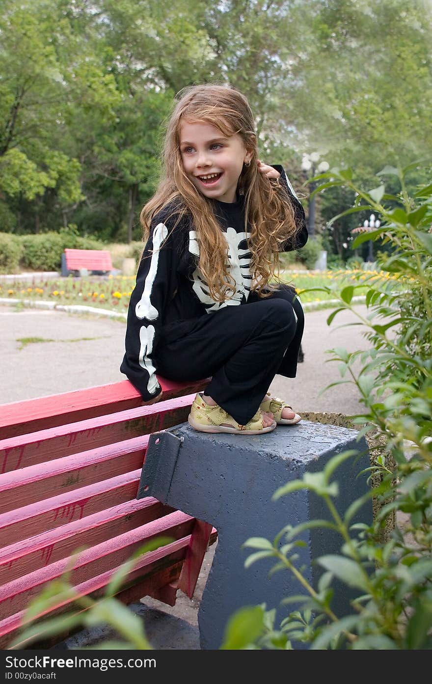 Little girl dressed as a sketeton makies faces. Little girl dressed as a sketeton makies faces