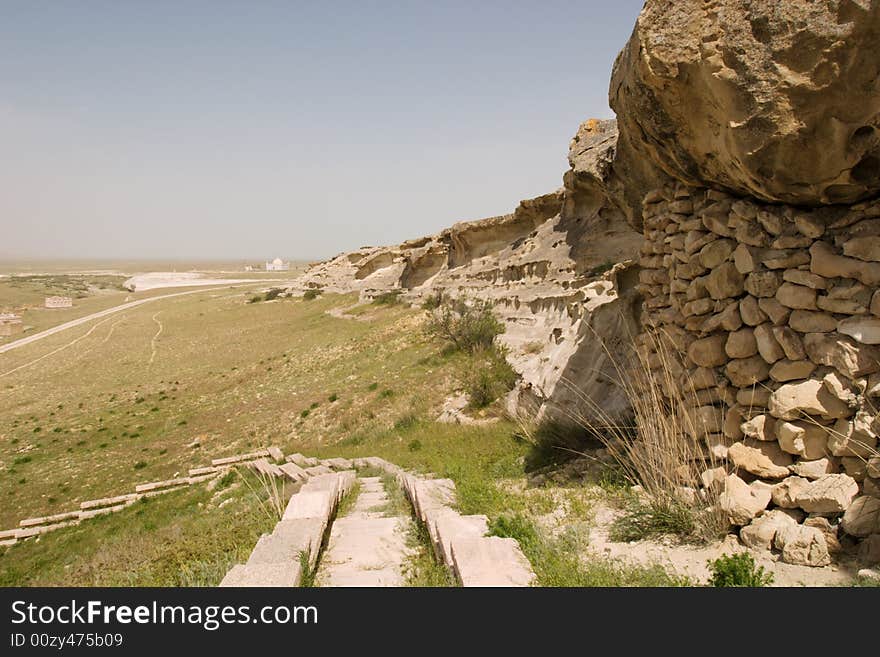 Stone stairway and sandstone wall against the blue sky. Stone stairway and sandstone wall against the blue sky