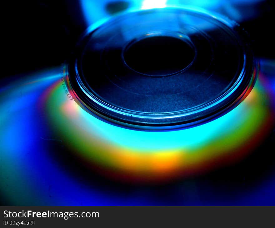 A close-up of a high technology data storage equipment - compact disc/ digital video disc with a  rainbow. A close-up of a high technology data storage equipment - compact disc/ digital video disc with a  rainbow.