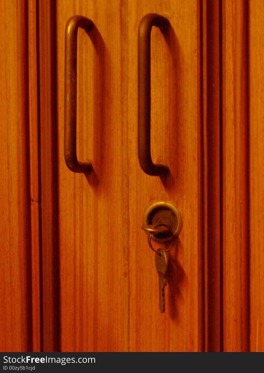 A wooden door frame, with brass fitting