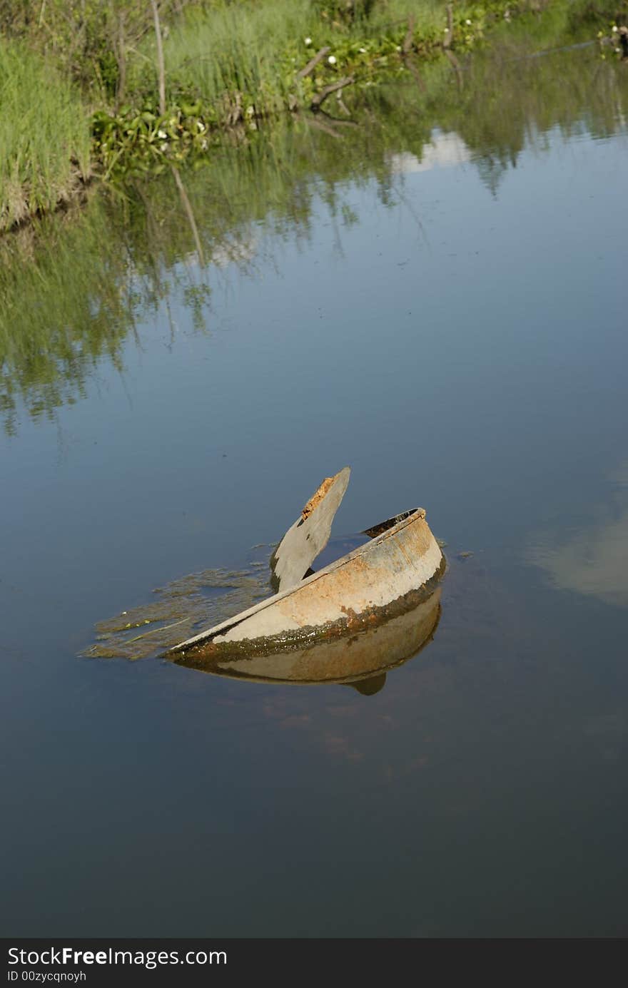 Old rusty barrel in a pond with still water. Old rusty barrel in a pond with still water