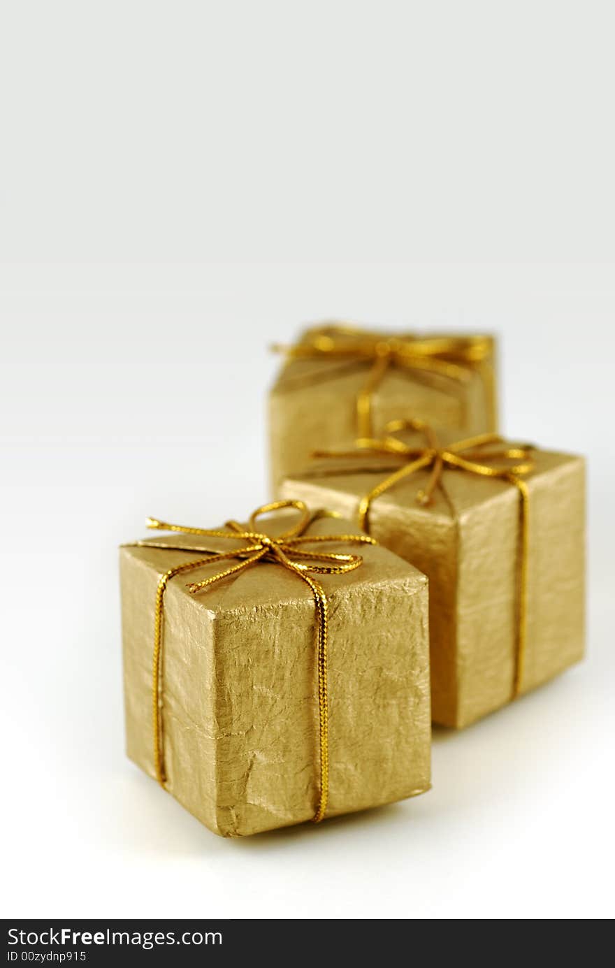 Three golden gift boxes