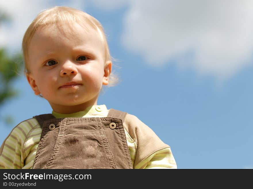 The beautiful little boy on a background of sky. The beautiful little boy on a background of sky