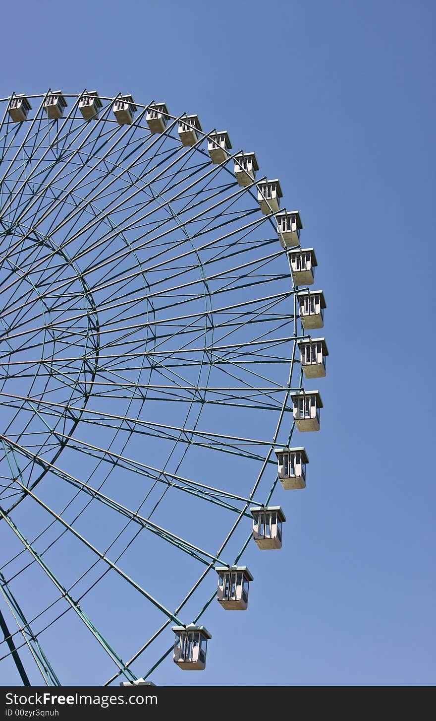 Ferris wheel with blue sky background.