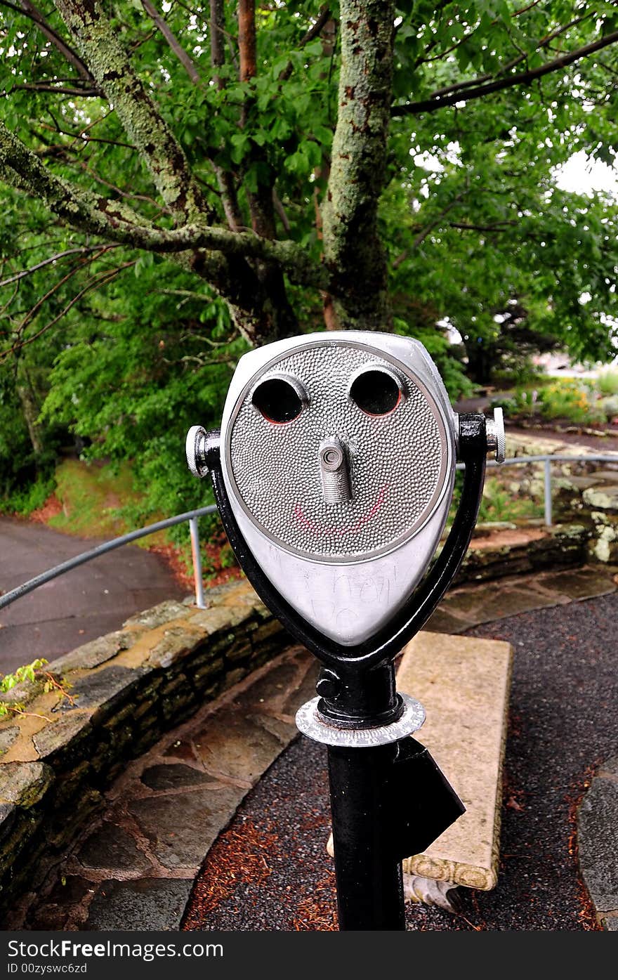 A coin operated binocular for viewing a landscape - face shaped. A coin operated binocular for viewing a landscape - face shaped.