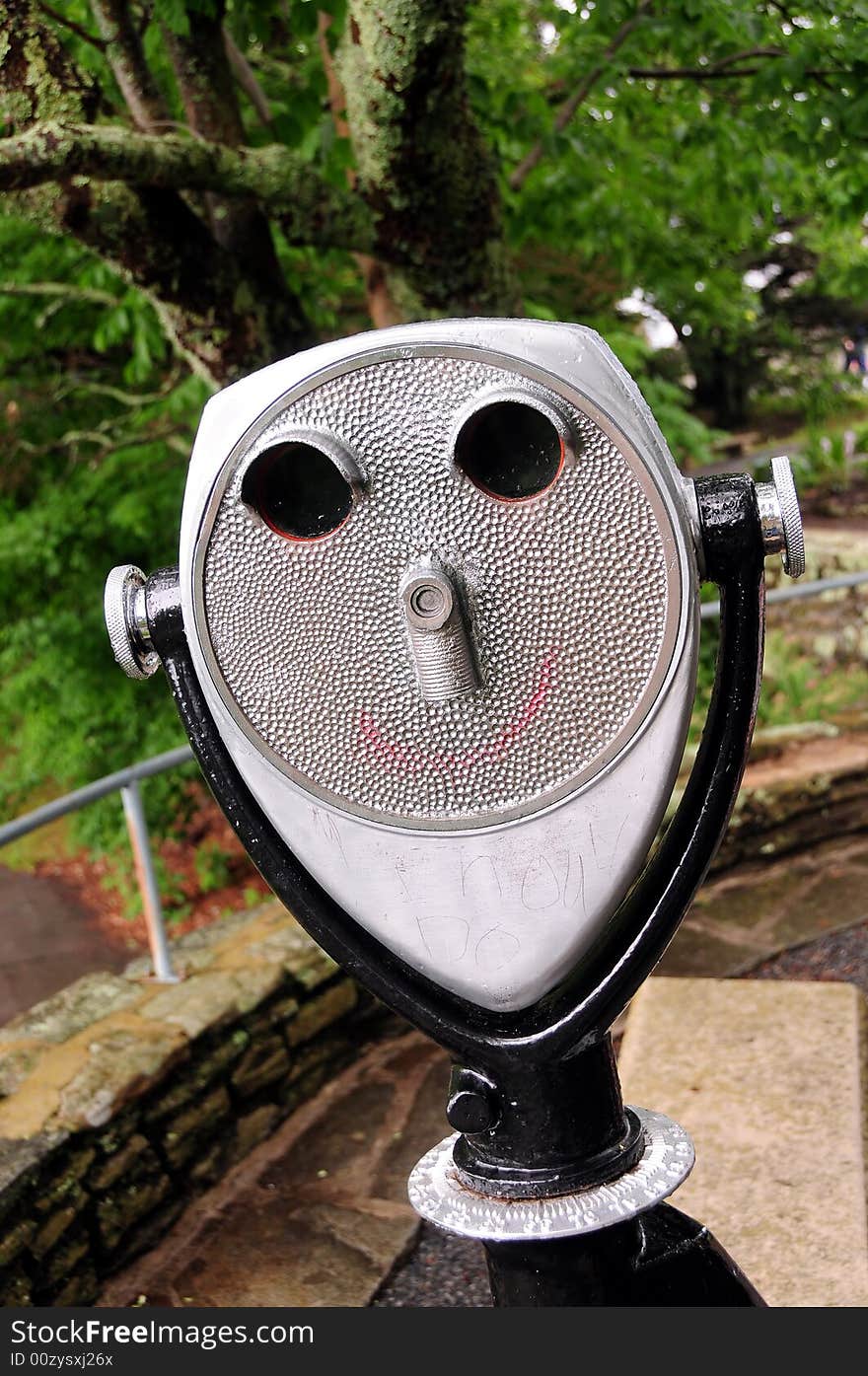 A coin operated binocular for viewing a landscape - face shaped. A coin operated binocular for viewing a landscape - face shaped.