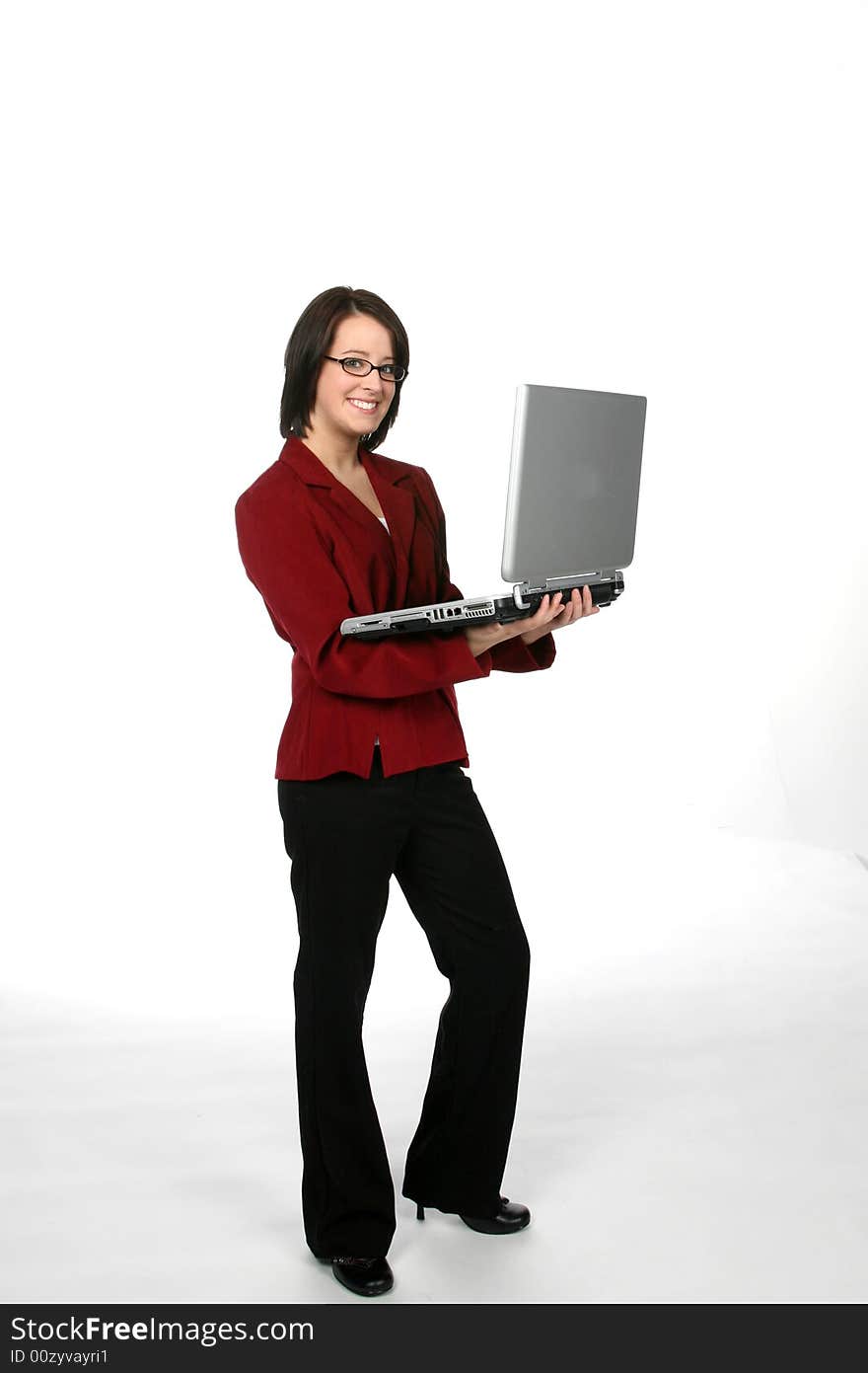 Laptop being held b a teenage girl in a casual business suit. Laptop being held b a teenage girl in a casual business suit