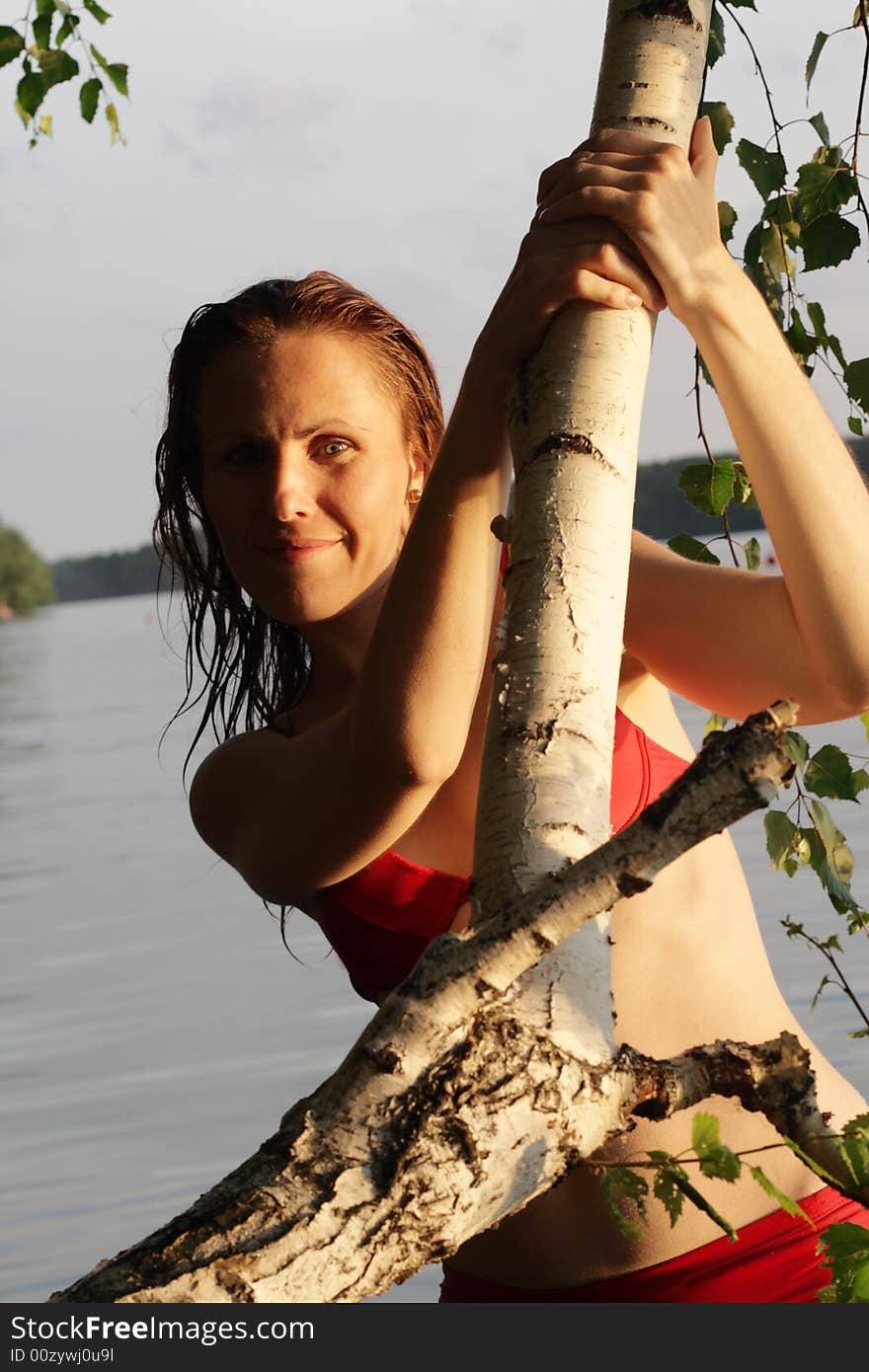 Woman Smile by Tree and Leaves in Water. Woman Smile by Tree and Leaves in Water