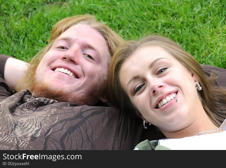 Young man and woman laying on the grass. Young man and woman laying on the grass