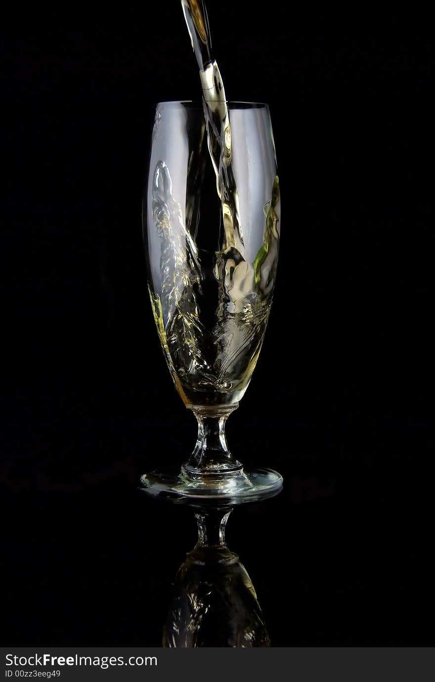 Glass of drink poured on black background. Glass of drink poured on black background