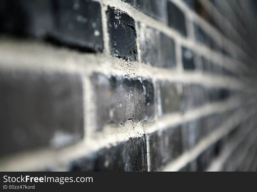 A black brick wall - it looks almost like a black and white photograph, but it is in fact color.