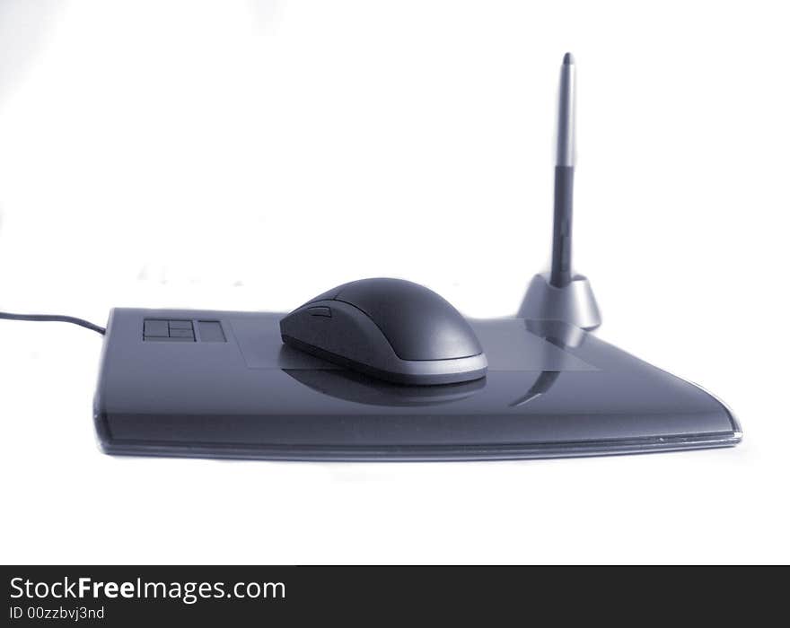 A wireless computer mouse on white with a pen and tablet. Has a slight blue color cast. A wireless computer mouse on white with a pen and tablet. Has a slight blue color cast.