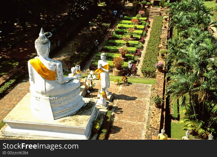 Row Of Buddha Statues With Yellow And Orange Cape