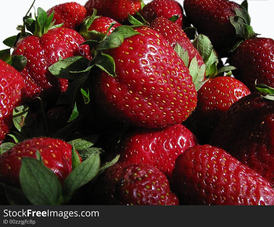 A pile of strawberries on a white background. A pile of strawberries on a white background