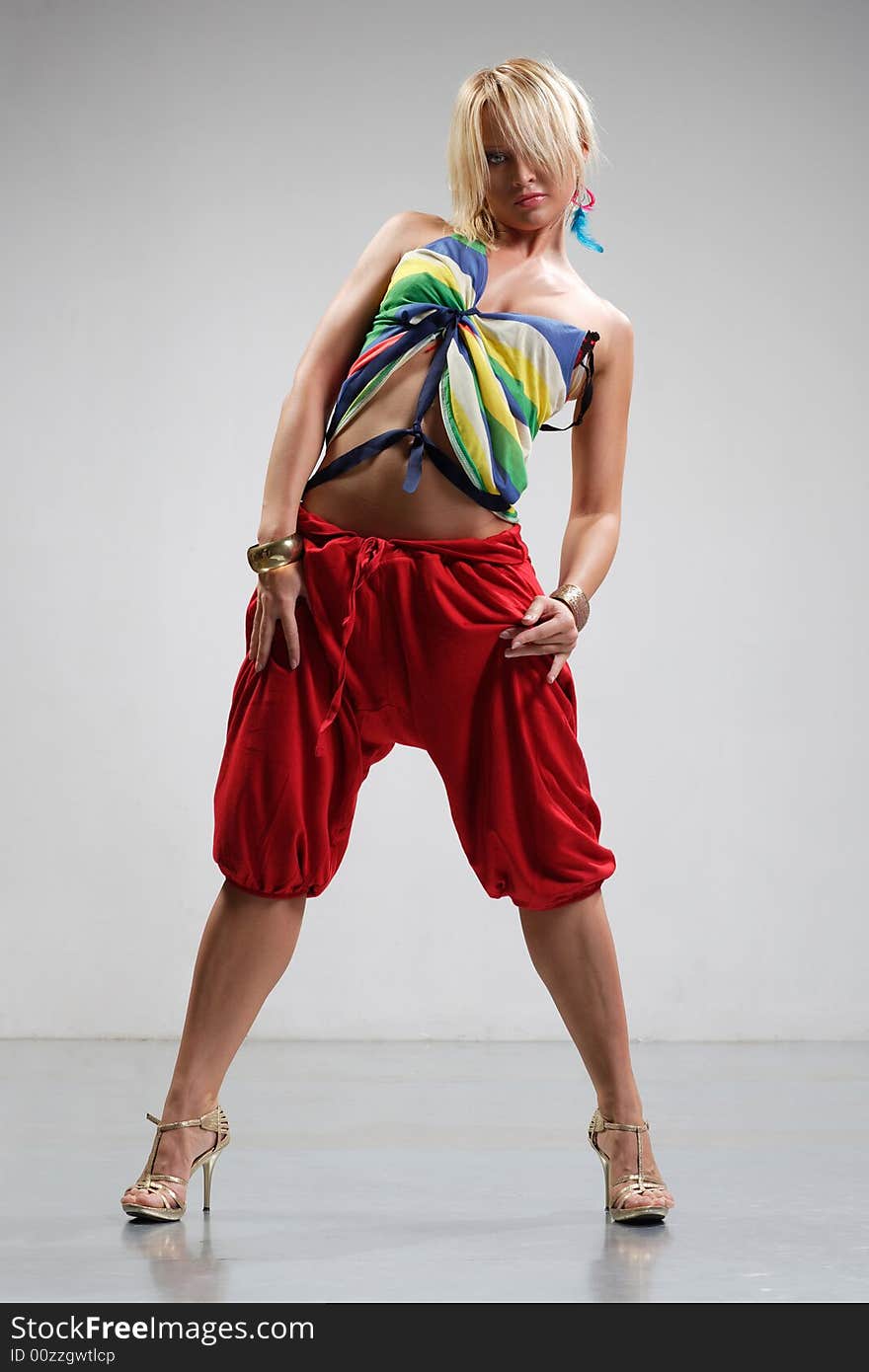 Rastafarian style dancer posing on a grey background. Rastafarian style dancer posing on a grey background