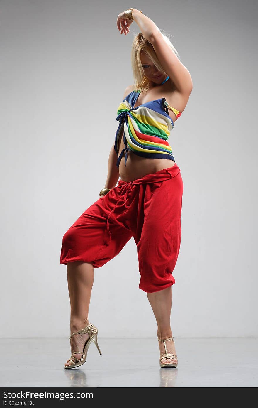 Rastafarian style dancer posing on a grey background. Rastafarian style dancer posing on a grey background