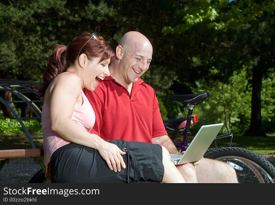 Couple on Park Bench with Laptop - Horizontal