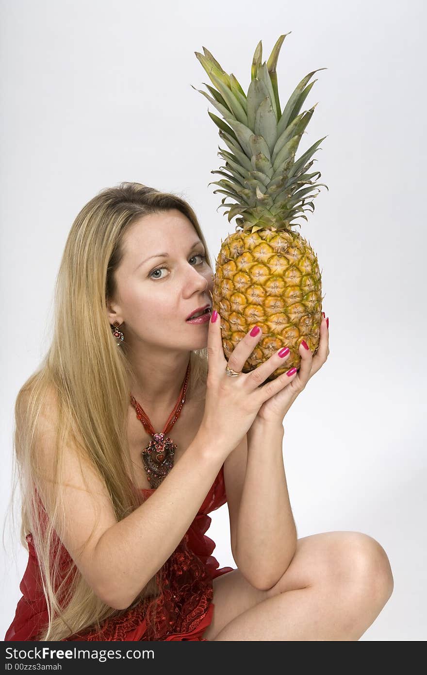 Blonde long hair woman with a pineapple in her hands. Blonde long hair woman with a pineapple in her hands