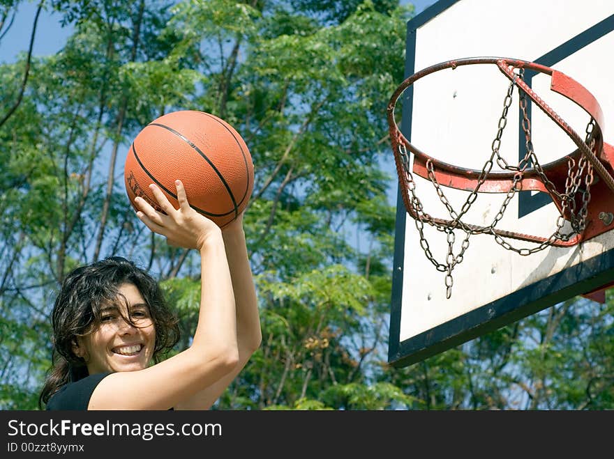 Woman Playing Basketball At Park - Horizontal