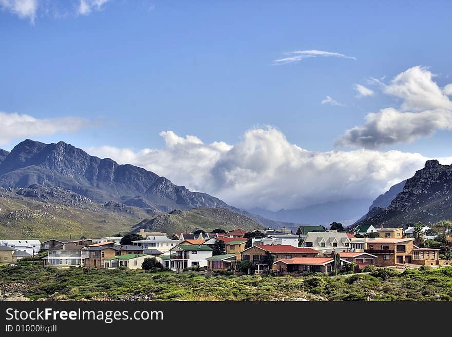 Storm approaching over the mountain towards a quiet village. Storm approaching over the mountain towards a quiet village