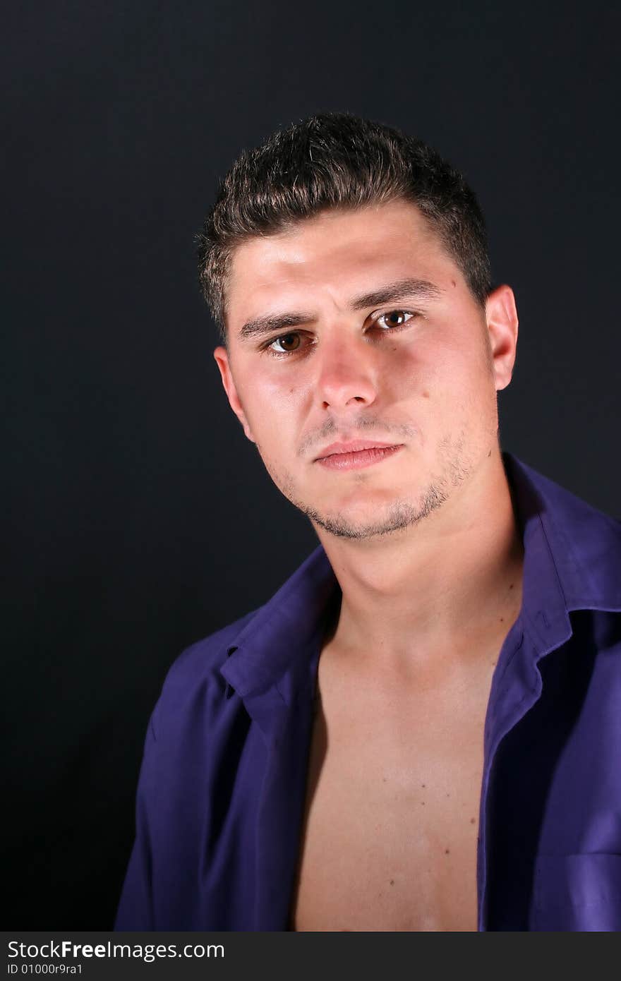 Male model in studio against a dark wall