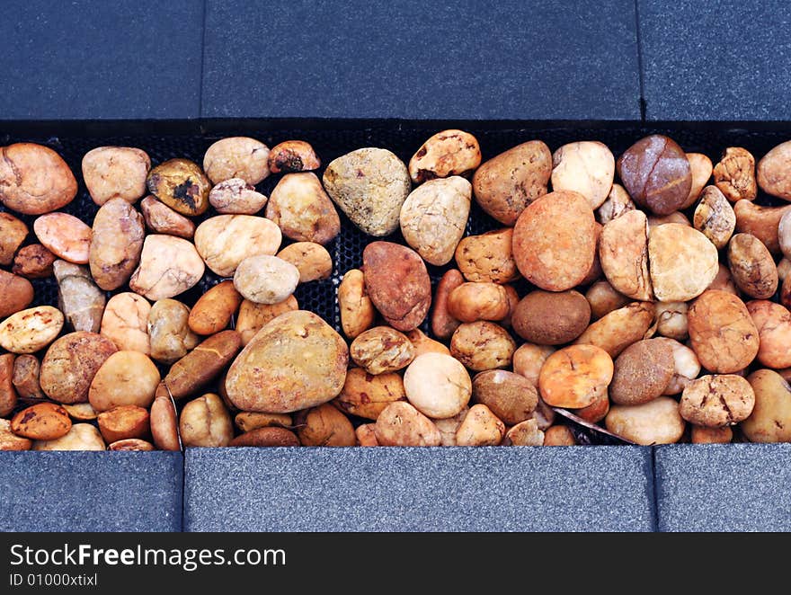 Close-up of brown stone pebbles in a garden.