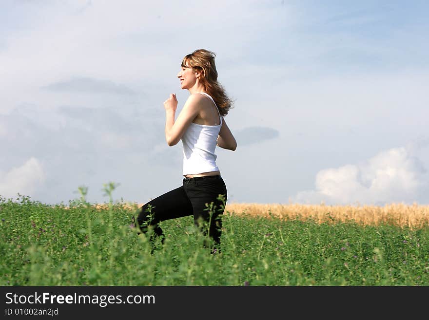 A beautiful girl running on the field