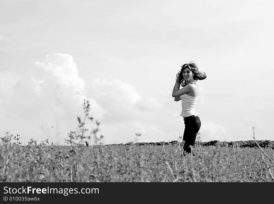 A beautiful girl jumping on the field