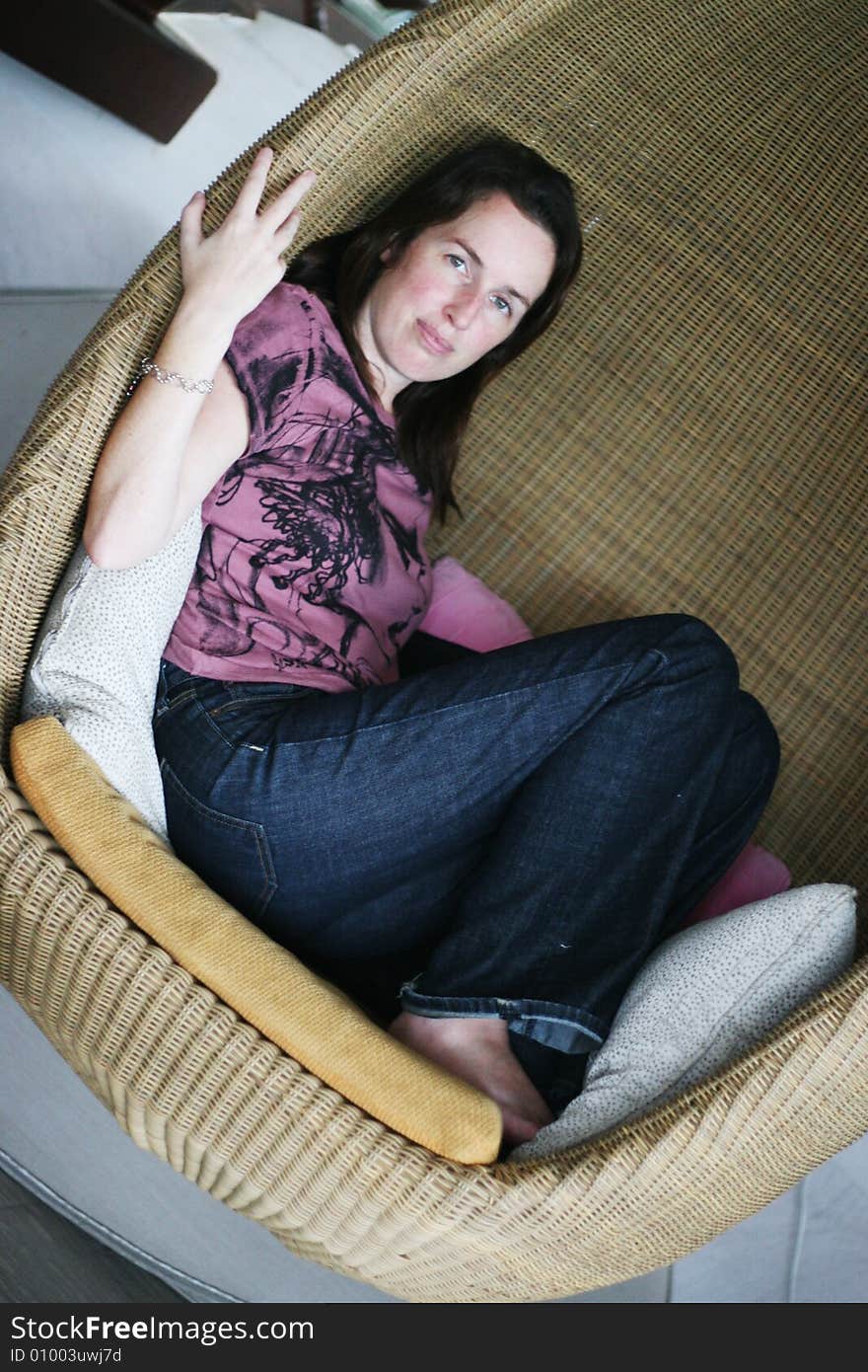 Portrait of a woman relaxing in a chair.