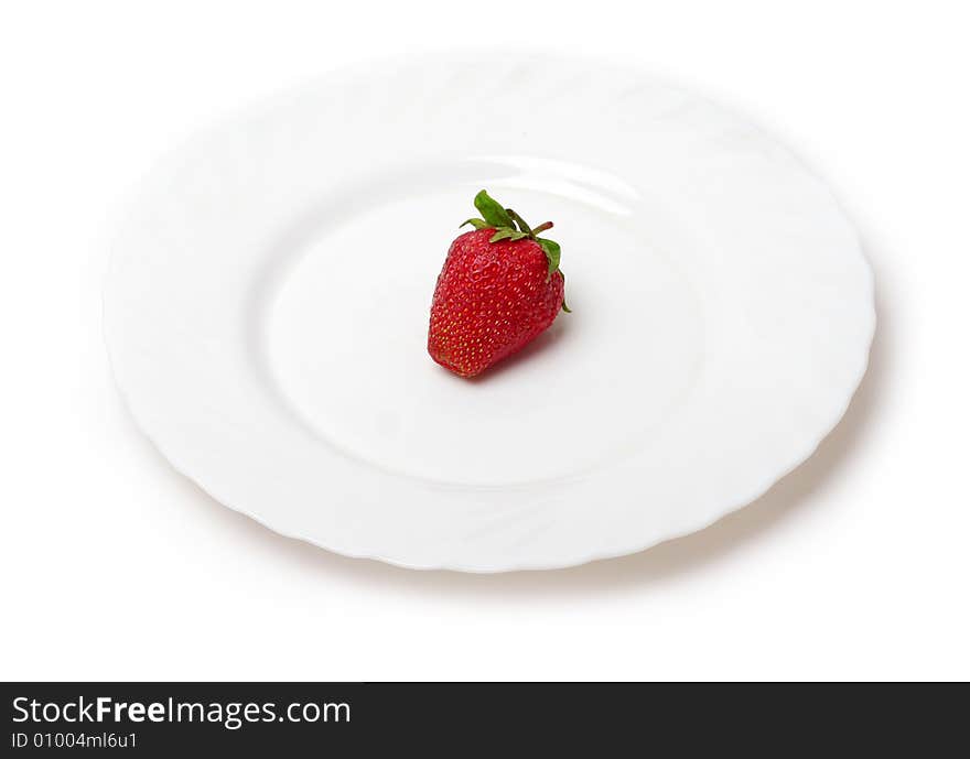 An appetizing strawberry on a white plate at the white background. An appetizing strawberry on a white plate at the white background