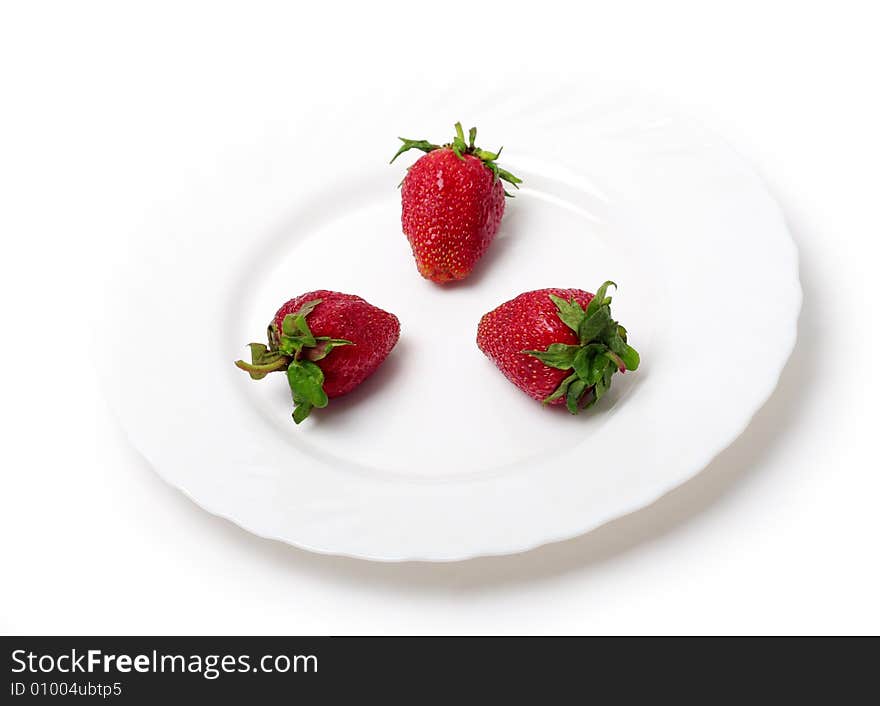 An appetizing strawberries on a white plate. An appetizing strawberries on a white plate