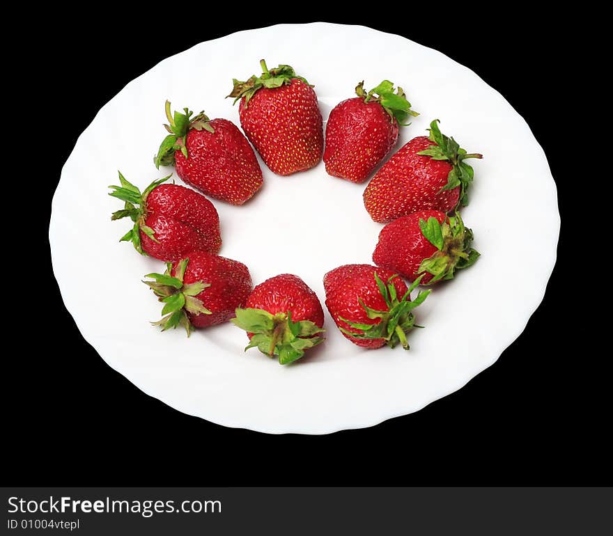 An appetizing strawberries on a white plate at the black background. An appetizing strawberries on a white plate at the black background