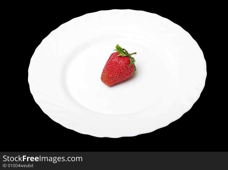 An appetizing strawberry on a white plate at thу black background. An appetizing strawberry on a white plate at thу black background