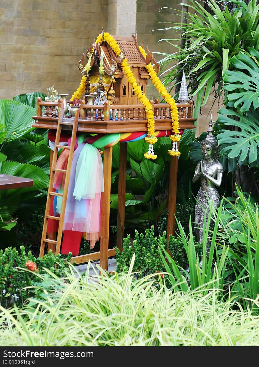 Offerings on a spirit house in Thailand - travel and tourism.