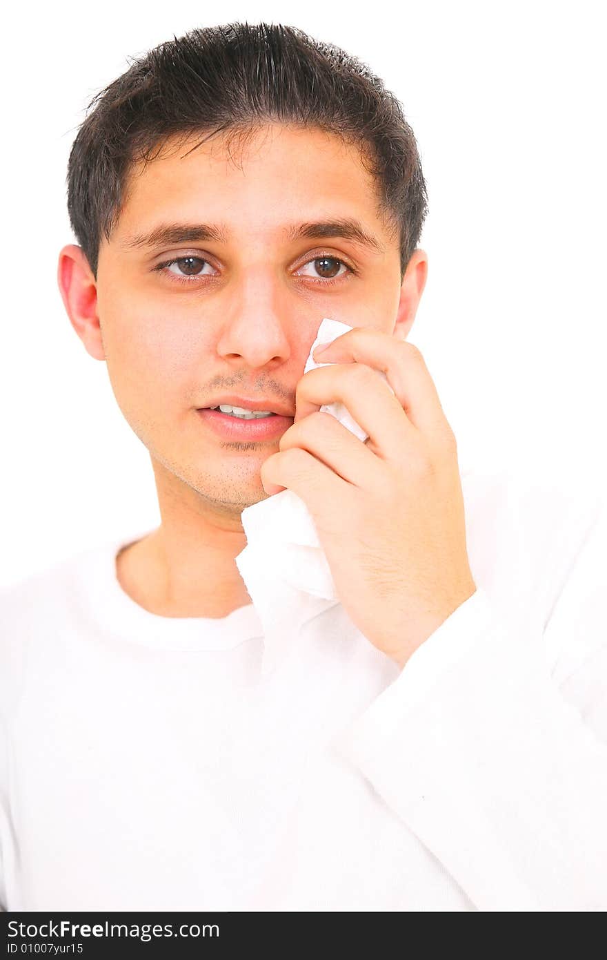 Close up of teenager wiping his tears away. isolated on white background. Close up of teenager wiping his tears away. isolated on white background