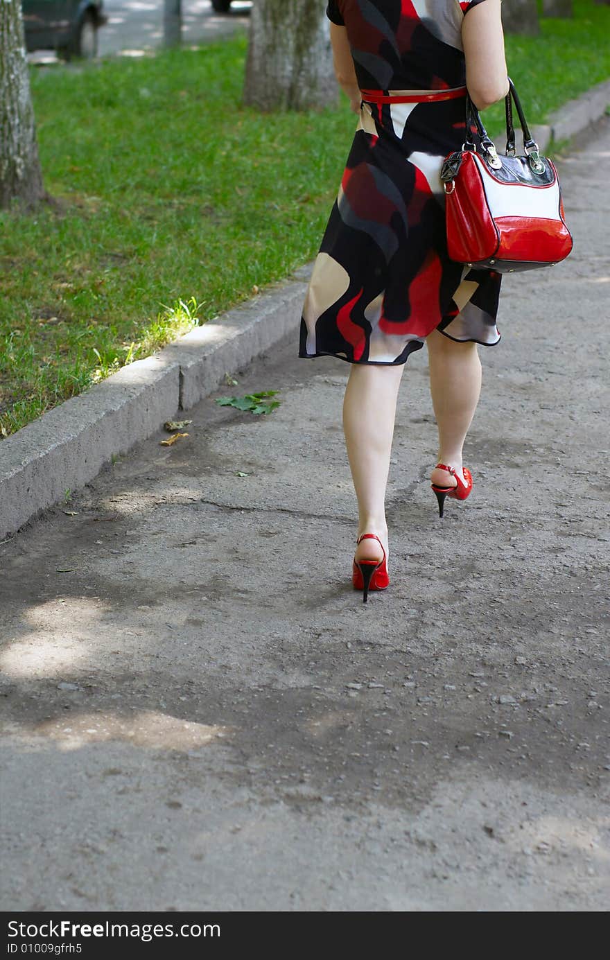 Womanish feet, red shoes and bag