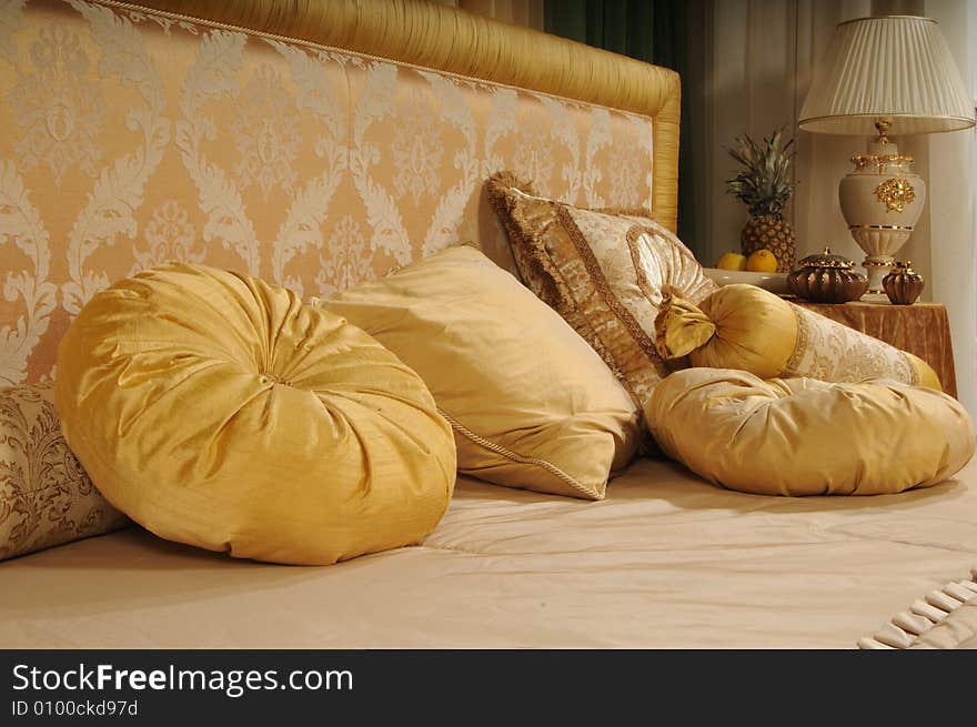 Decorative pillows on a bed at a headboard