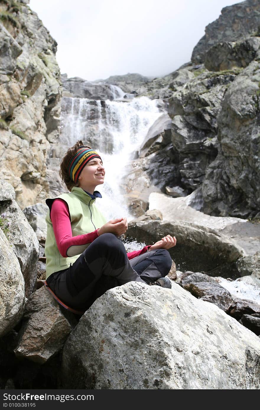 Girl near the waterfall, caucasus