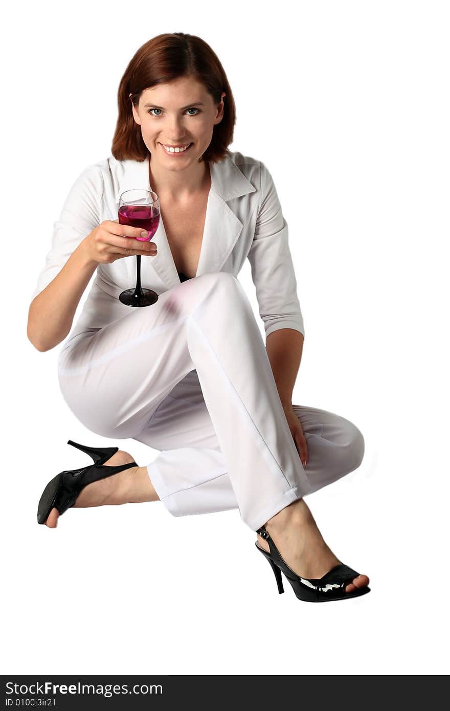 Business the woman in white clothes holds in a hand a glass with a bright drink. Business the woman in white clothes holds in a hand a glass with a bright drink