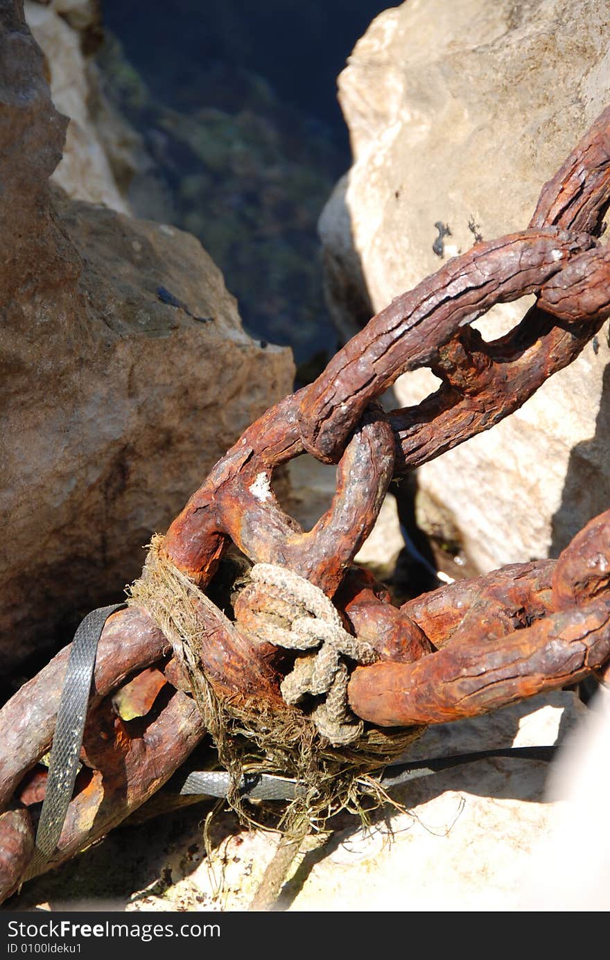 old chains for mooring boats on the rocks